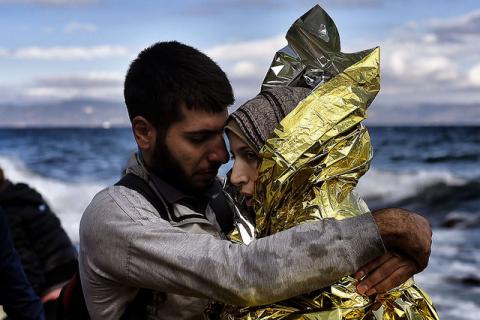 Refugees and migrants arrive at the Greek island of Lesbos after crossing the Aegean sea from Turkey on September 30, 2015