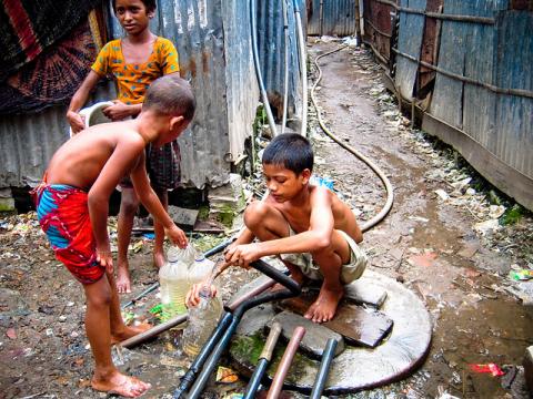 Children gather water in Dhaka, Bangladesh