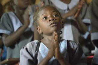 A student prays at the John Paul II School in Wau, South Sudan