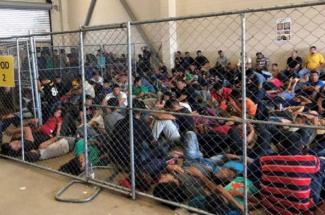 An overcrowded, fenced area holds families at a Border Patrol station in McAllen, Texas, on 10 June 2019. Reuters/Flickr.