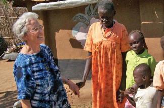 Maryknoll Sister Teresa Baldini with a family in Narus, South Sudan