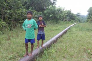 Children standing on Mongabay pipeline