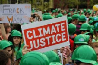 Climate justice sign in undated photo by CIDSE