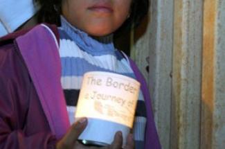 Child at prayer vigil at US-Mexico border wall